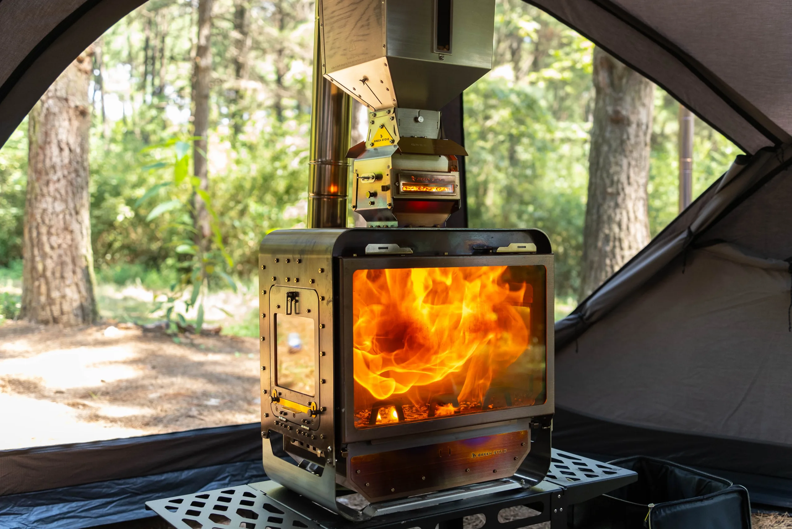 GreenEngine 3.0 Pro pellet burner feeding a large wood stove in a hot tent