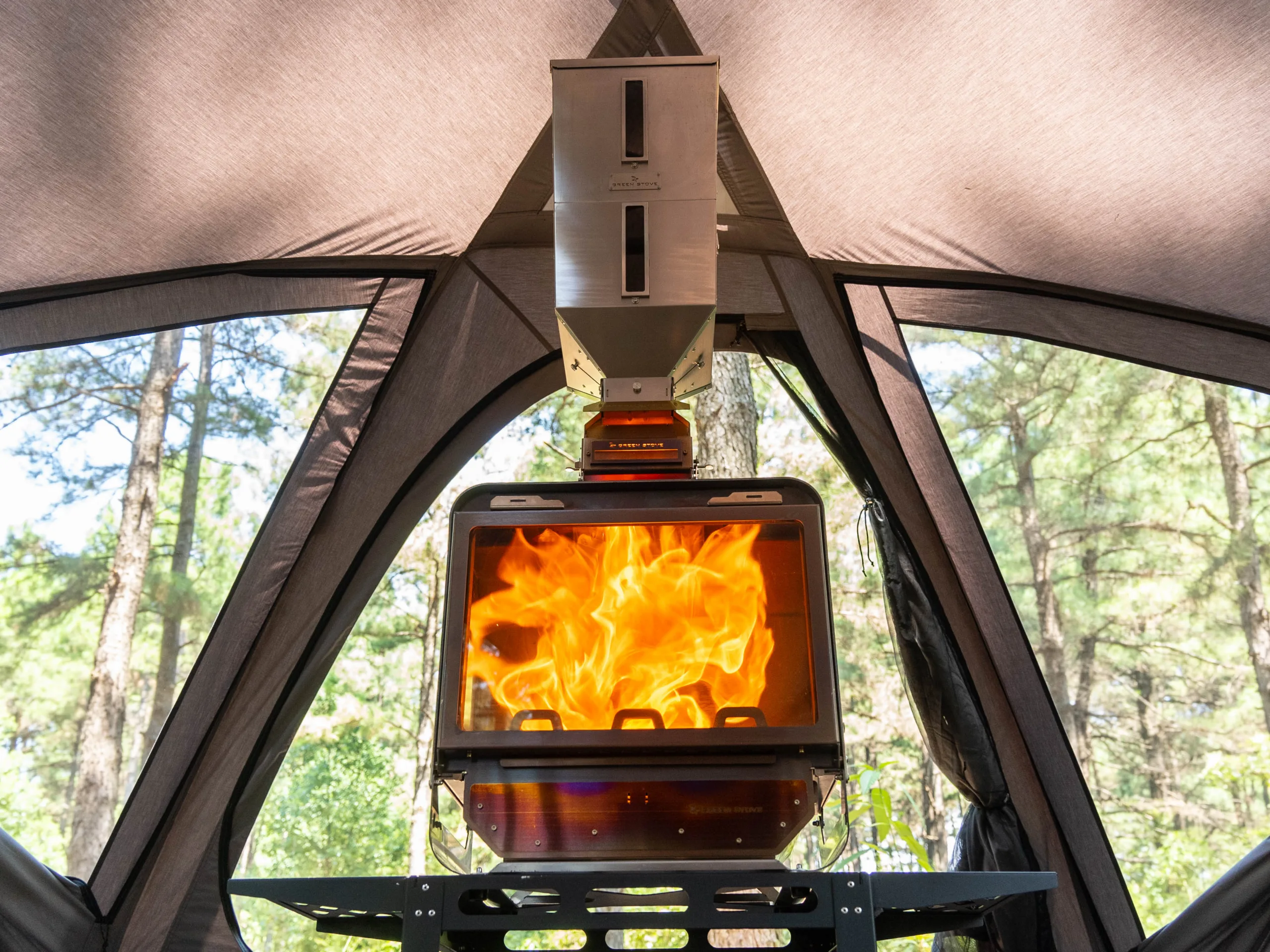 GreenEngine 3.0 Pro pellet burner and nesting hopper installed above a wood stove in a hot tent